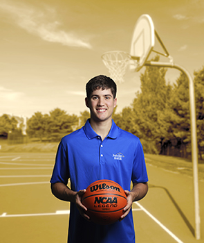 University of Kentucky Basketball player and Forcht Bank Ambassador Reed Sheppard holding a basketball on a court